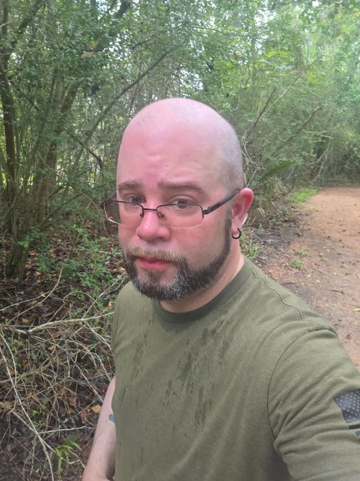 Efrain Ruiz standing on a wooded trail