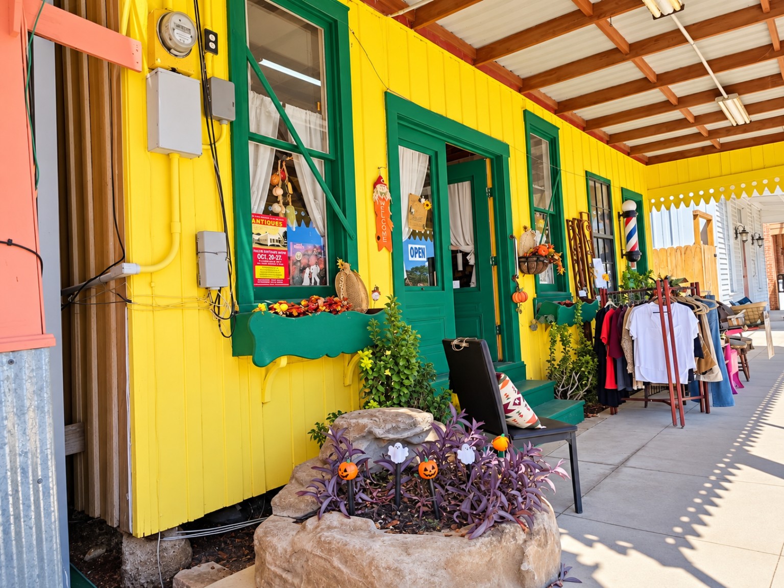Bright yellow storefront with green doors and autumn decorations