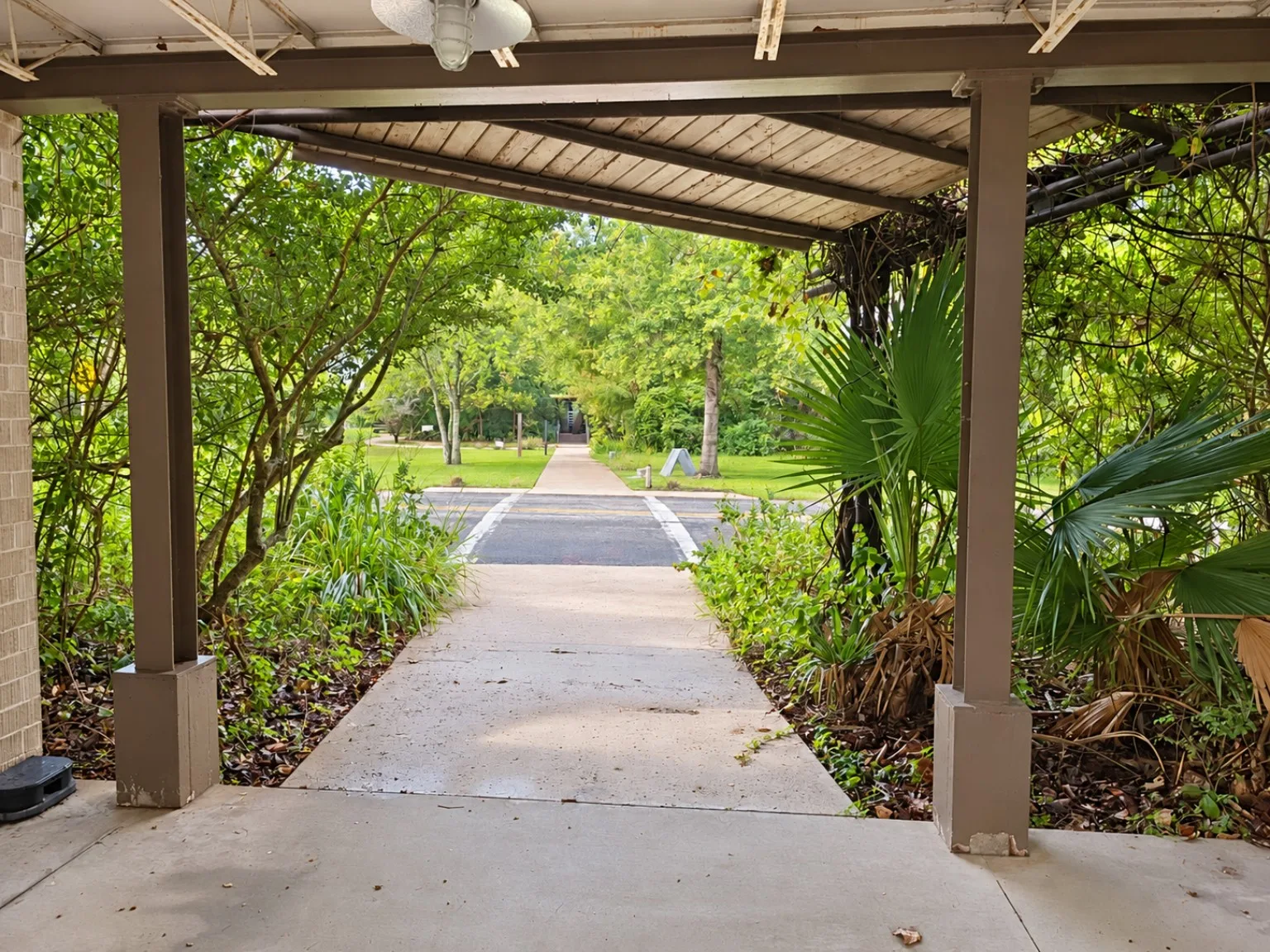 Covered walkway framing a path across a road