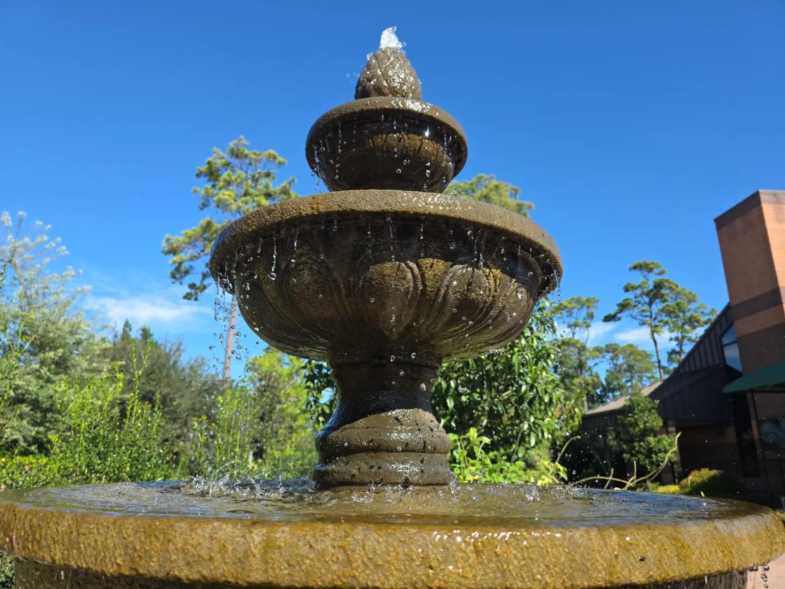 Tiered stone fountain against a blue sky